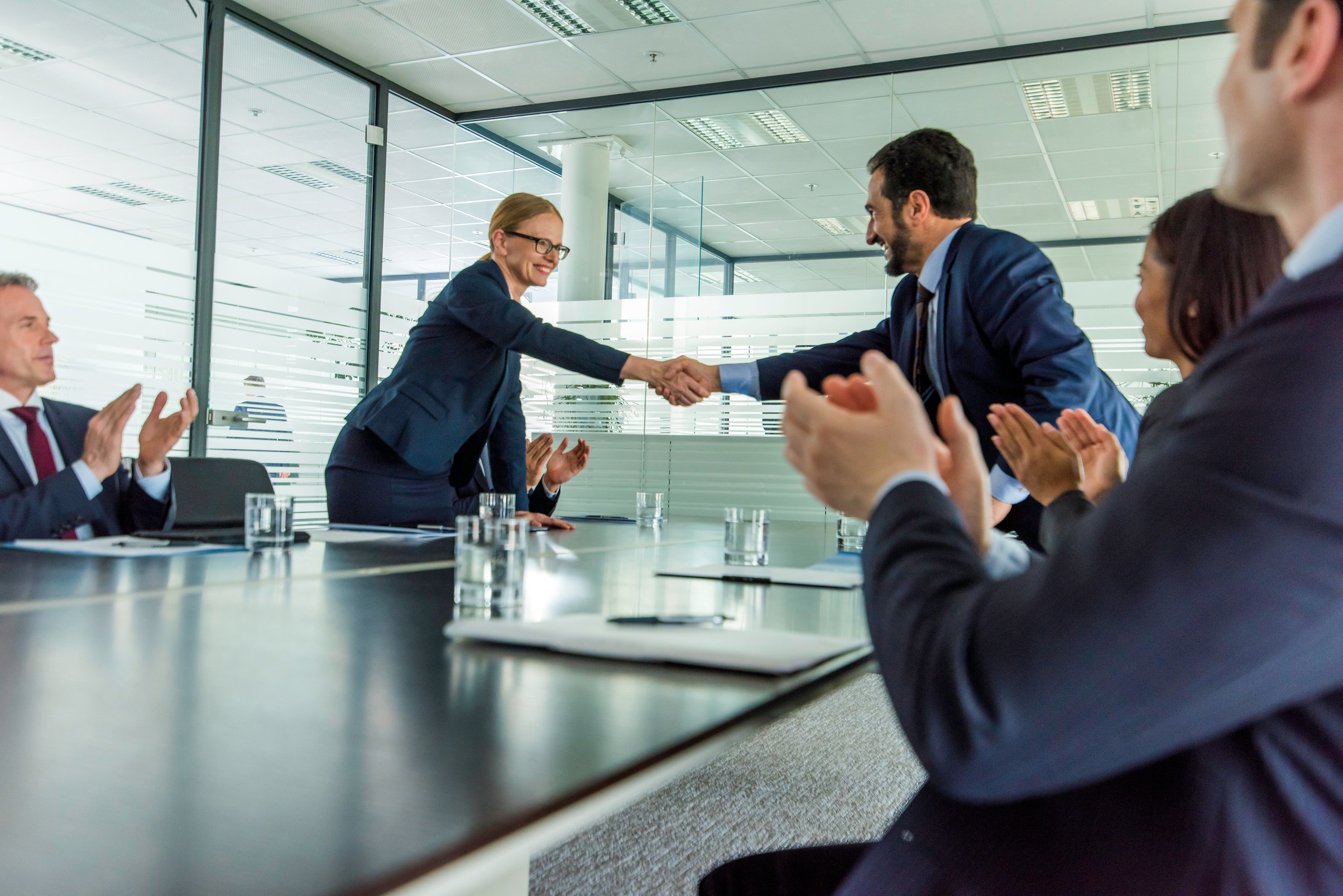 Handshake over conference table